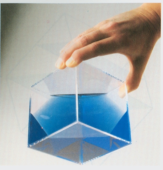 A transparent cube half filled with liquid